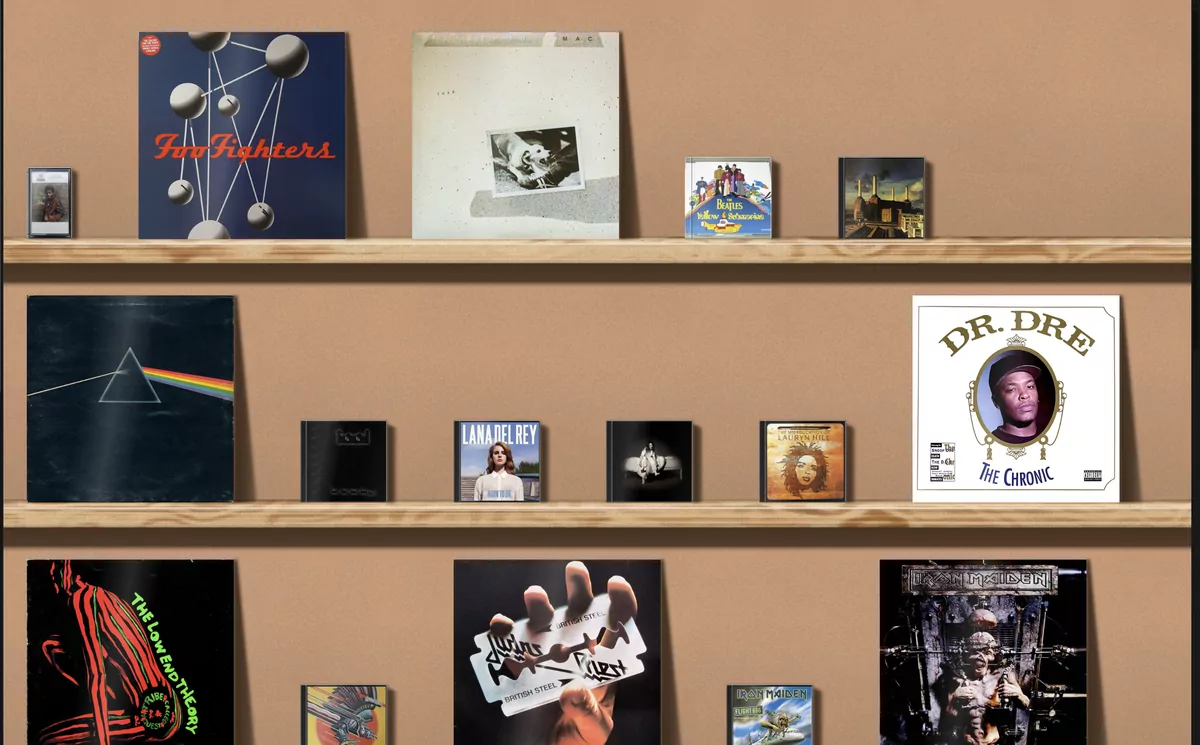 LP sleeves leaning against the wall beside much smaller CD cases on the same wooden shelves.